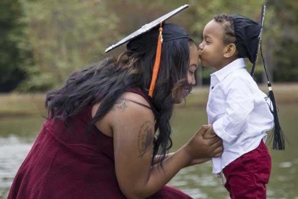 college mom with child where graduation caps